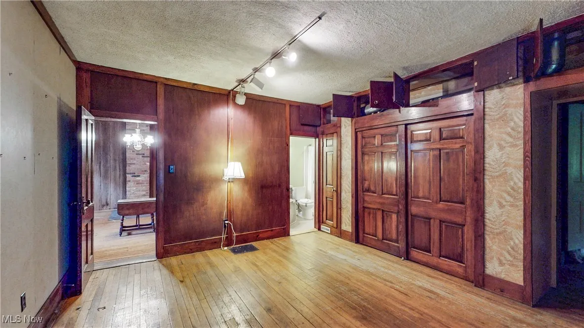 Living Room / 1st floor BR w/access to full bath, wall of closets & storage w/access to Dining Room, Stairway to 2nd level, Family Room & Mudroom