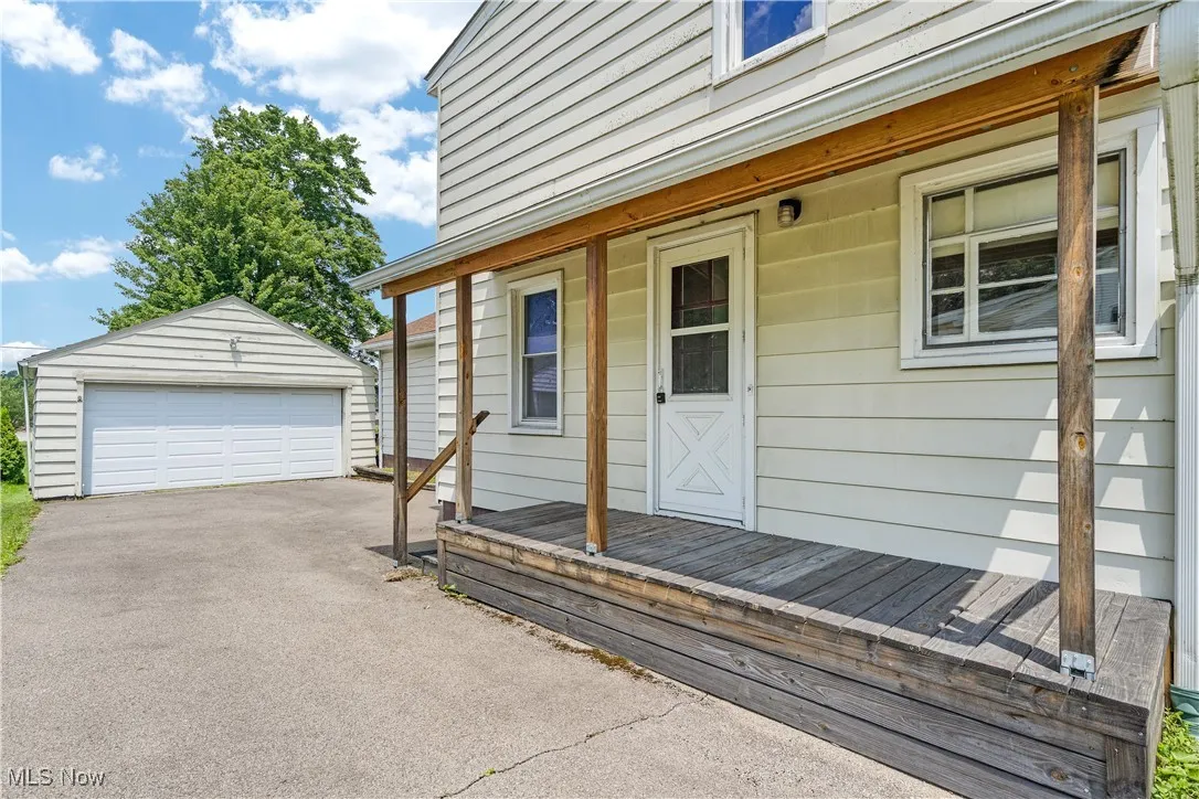 Entrance to property with a detached garage