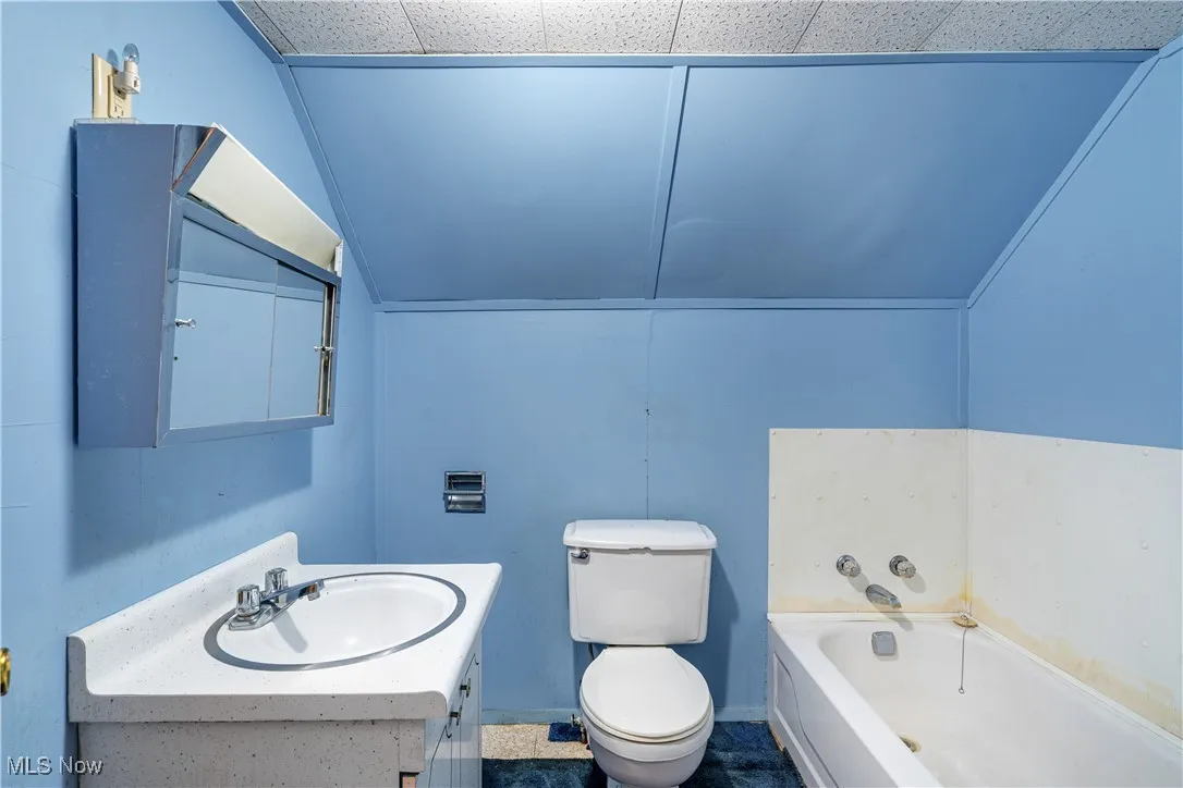 Bathroom featuring a bath and vanity