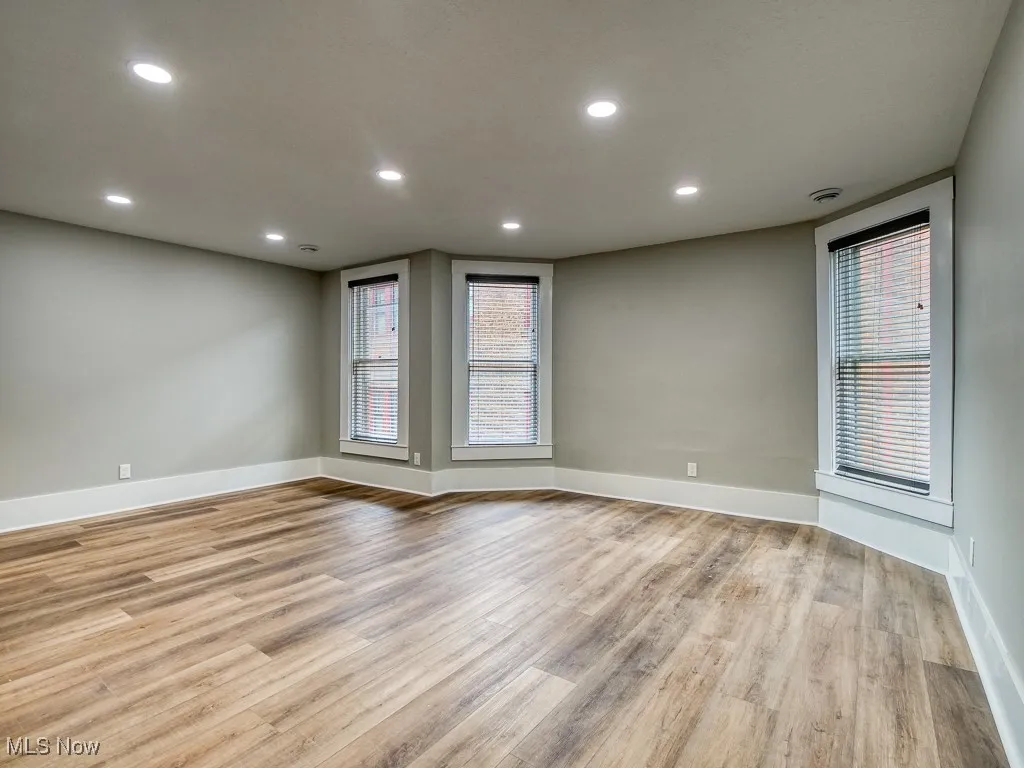 Unfurnished room featuring light wood-style floors, recessed lighting, and healthy amount of natural light