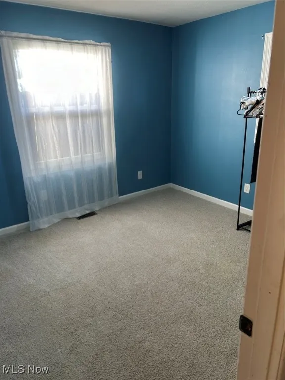 Empty room featuring carpet flooring