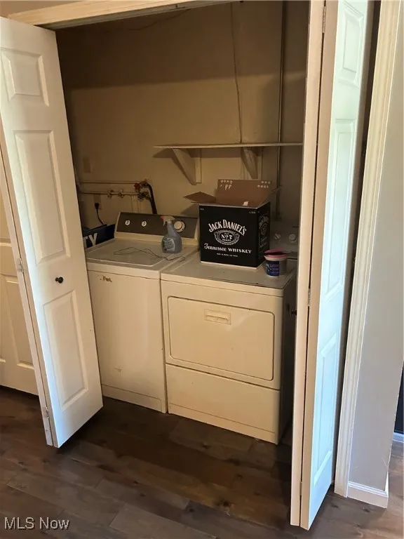 Laundry area featuring washing machine and dryer and dark wood-style flooring