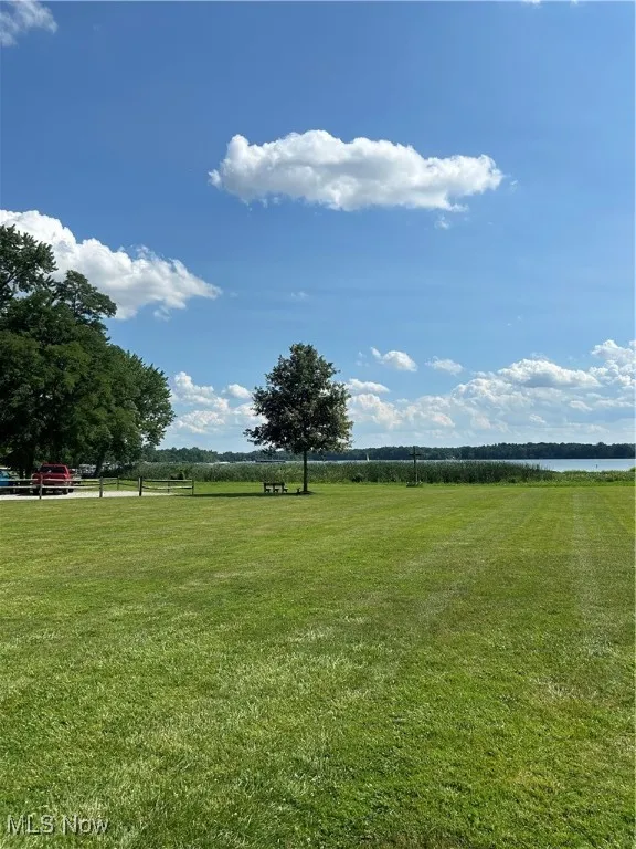 View of grassy yard with a water view