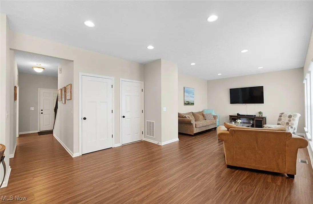 Living room featuring wood finished floors and recessed lighting