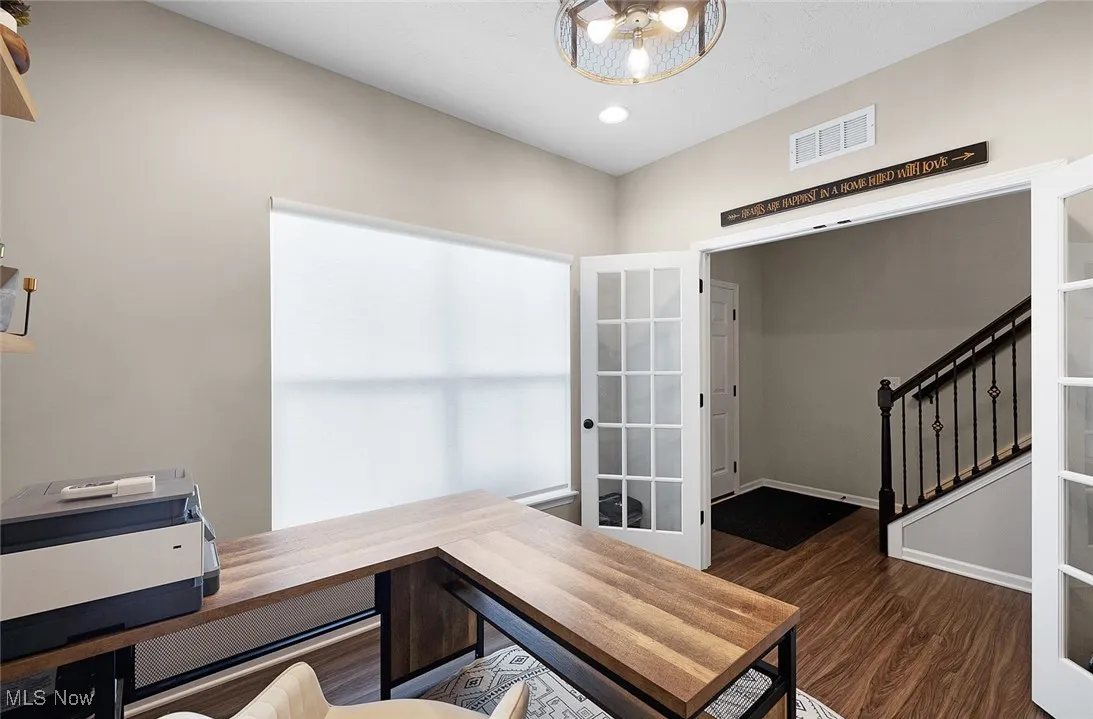 Office space featuring dark wood finished floors and recessed lighting
