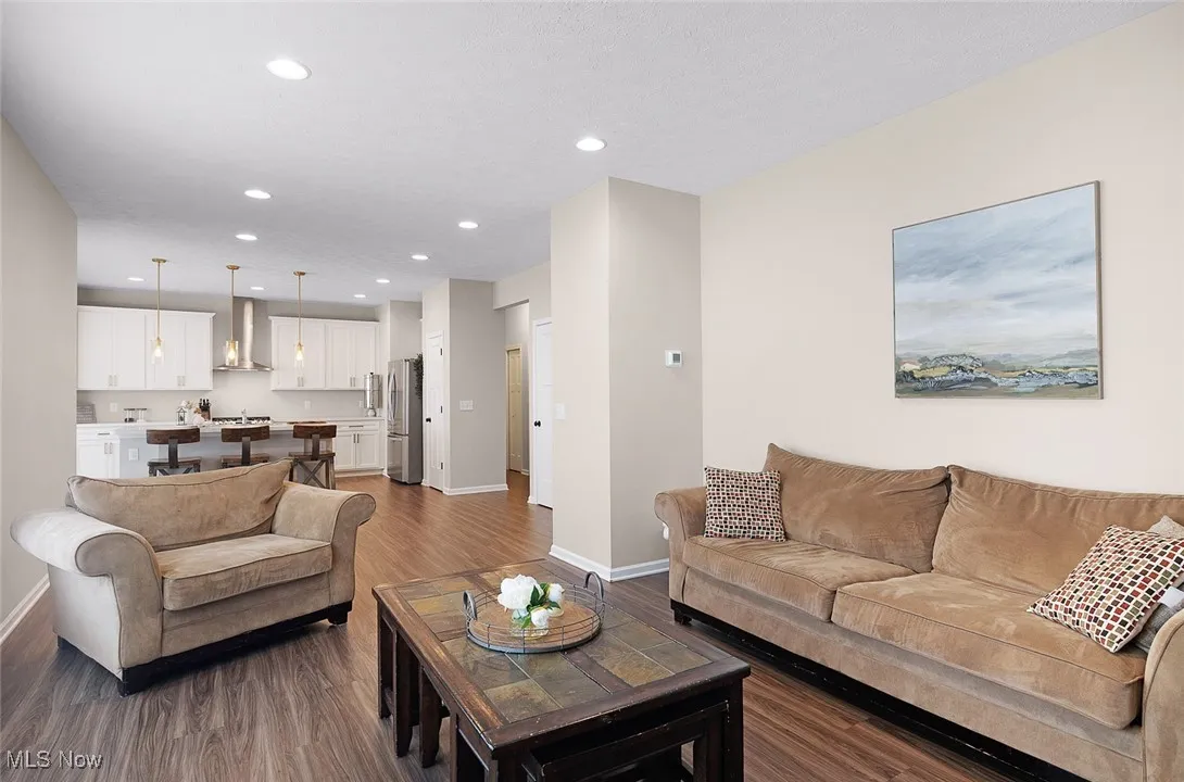Living room with recessed lighting and wood finished floors