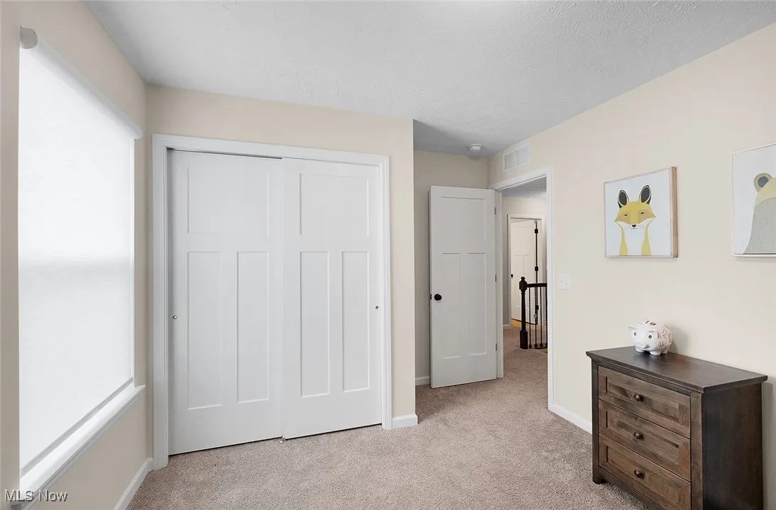 Bedroom with carpet and a closet