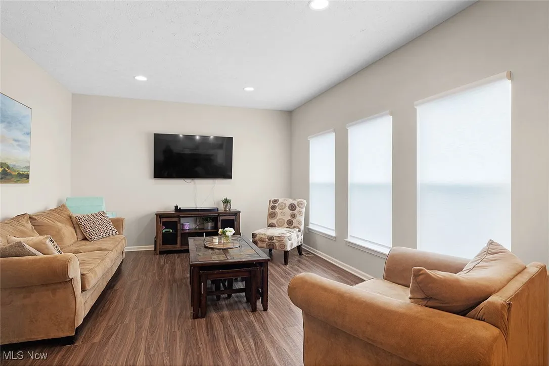 Living room featuring dark wood finished floors and recessed lighting