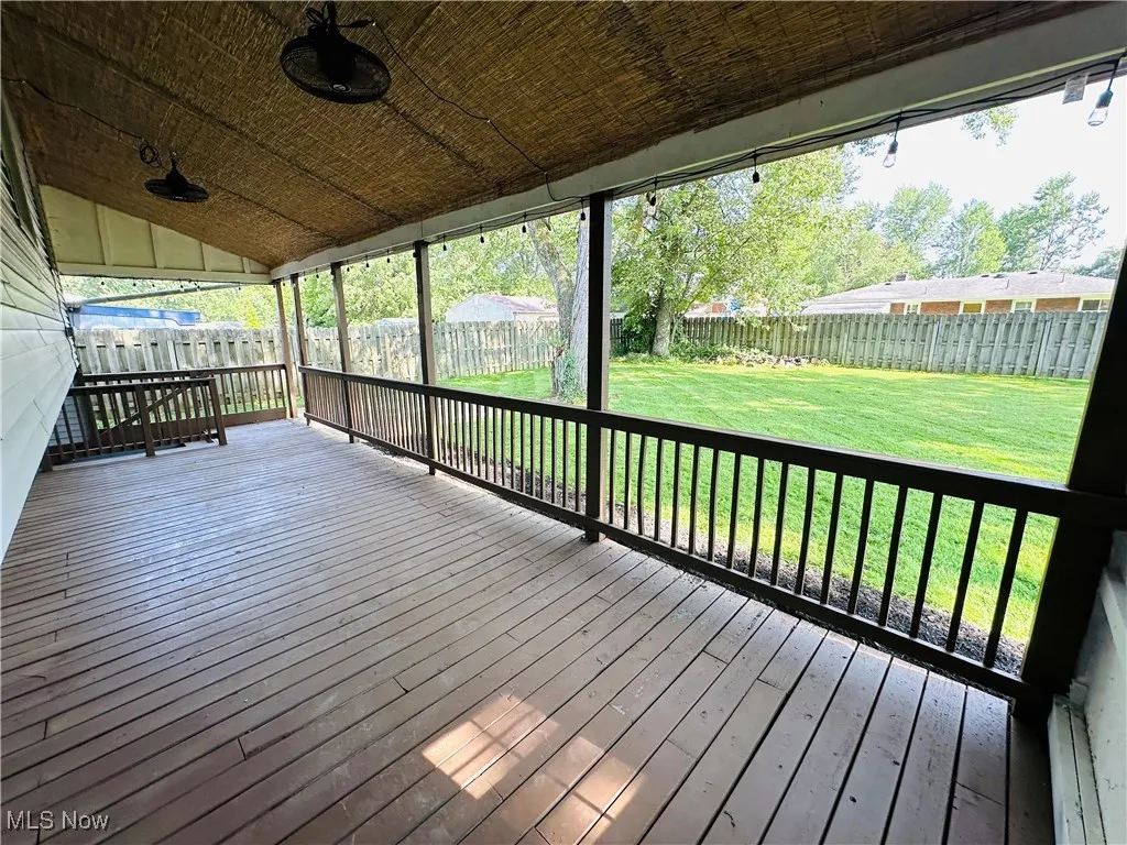 Wooden terrace with a fenced backyard and 2 exterior ceiling fans!