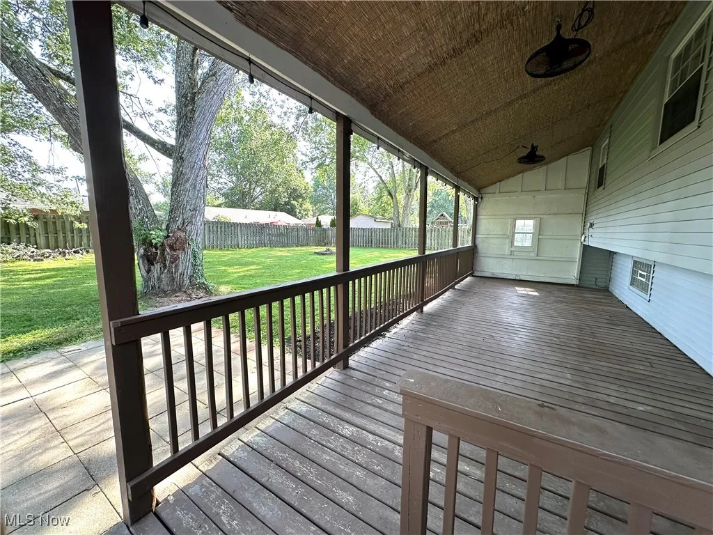 Wooden deck featuring a fenced backyard