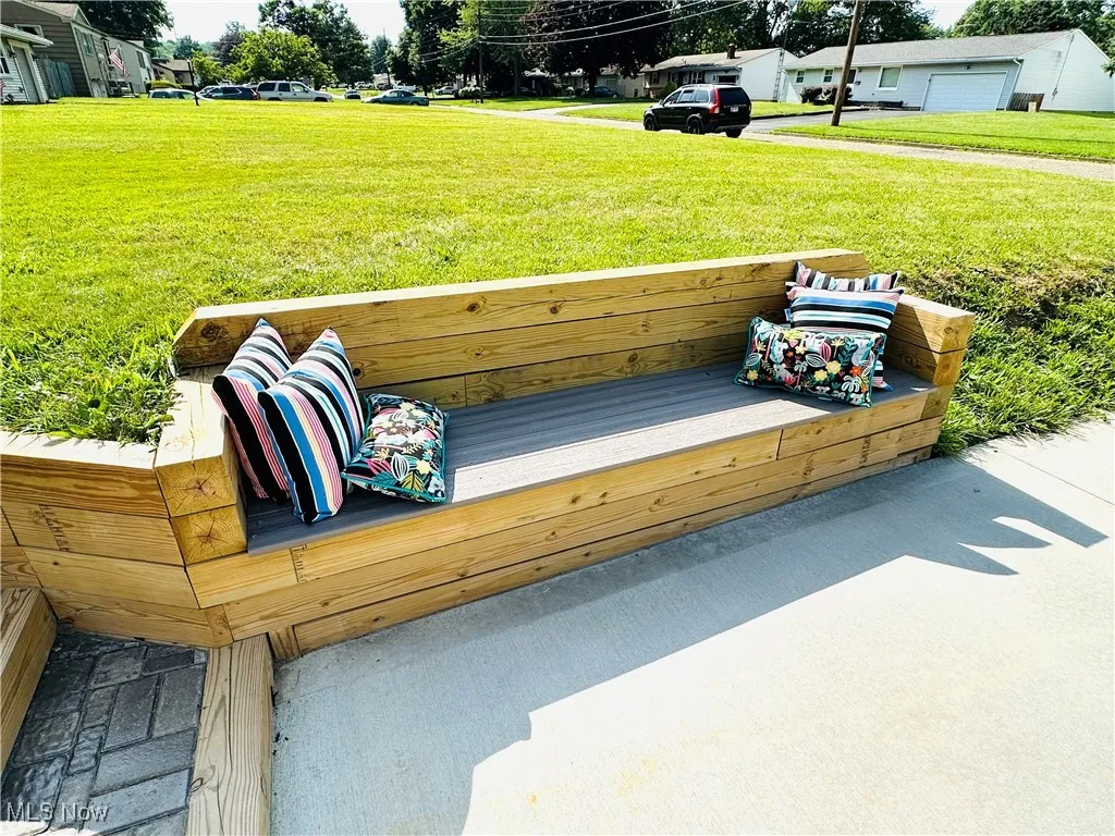 Deck with a yard and close up of custom bench.