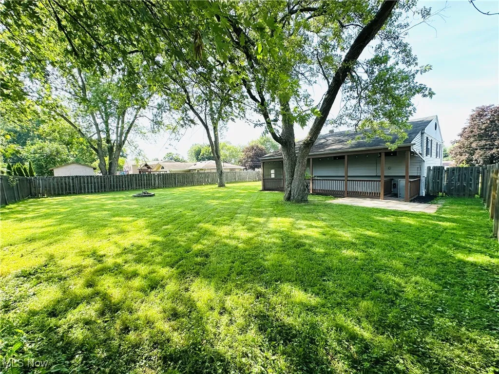 Fenced backyard featuring a patio