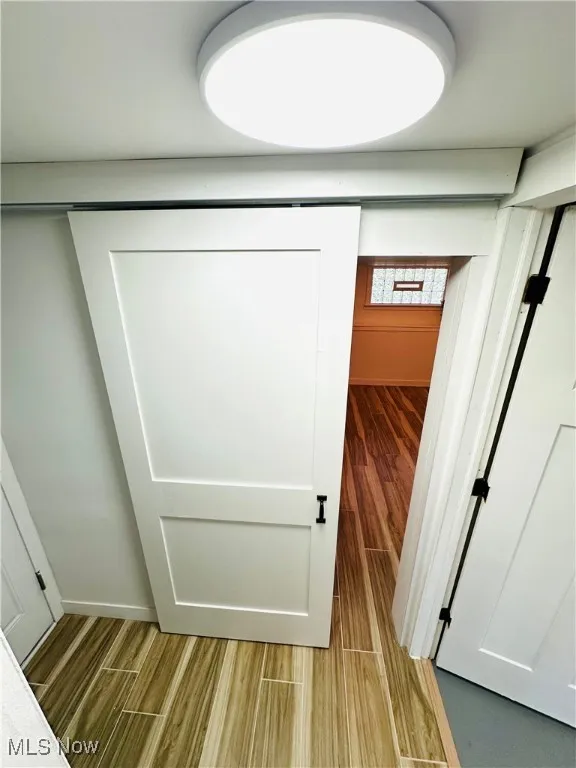 Detailed view of wood finished floors & new barn door!