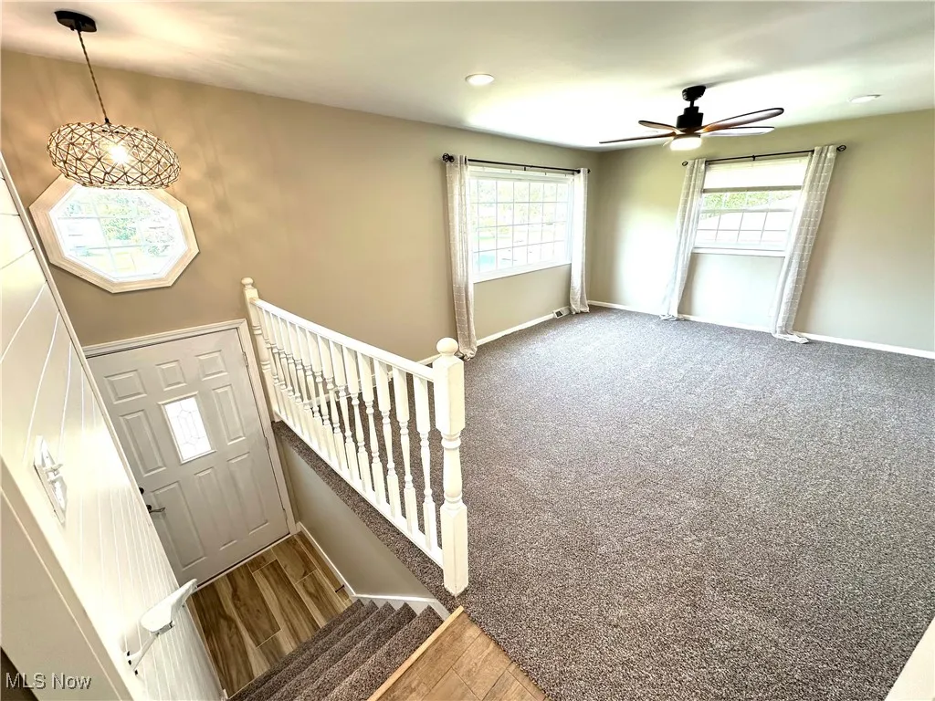 Foyer with new ceiling fan, recessed lighting, and wood finished floors