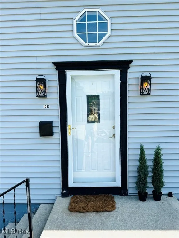 View of exterior entry door w/new light fixtures!