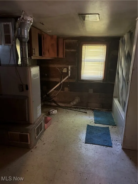 Kitchen with tile patterned floors and brown cabinetry