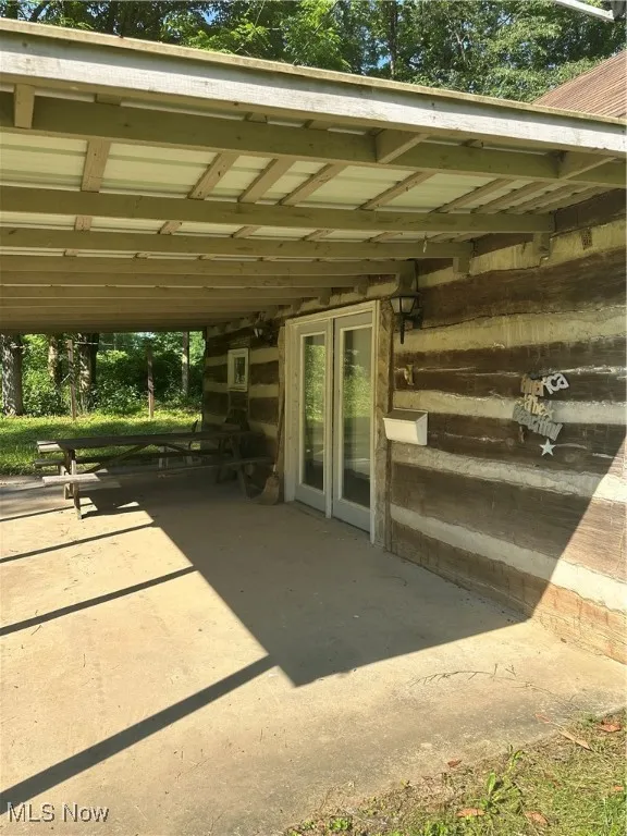 View of covered patio with french doors