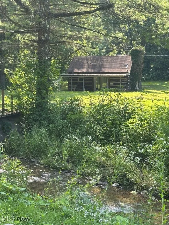 View of yard featuring a view of trees, town fork creek