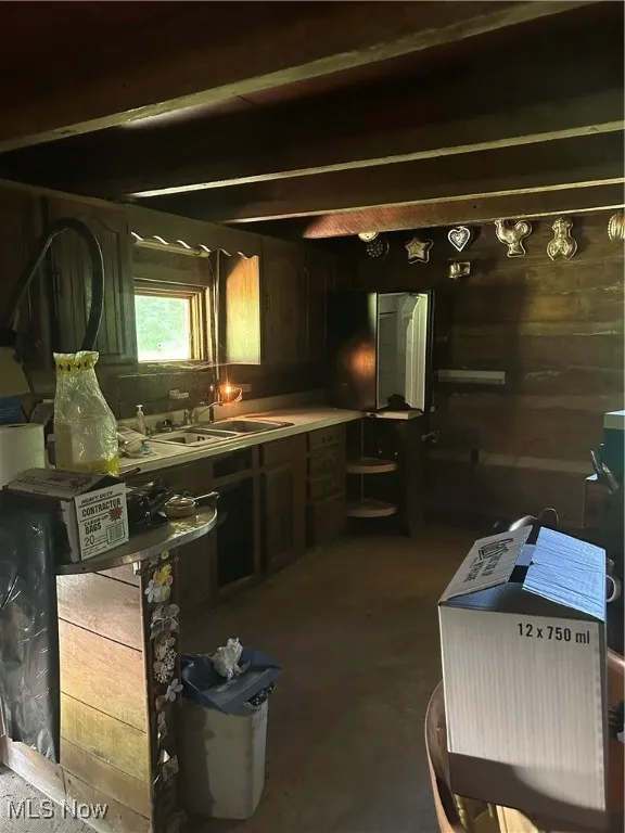 Kitchen with a sink and unfinished concrete flooring