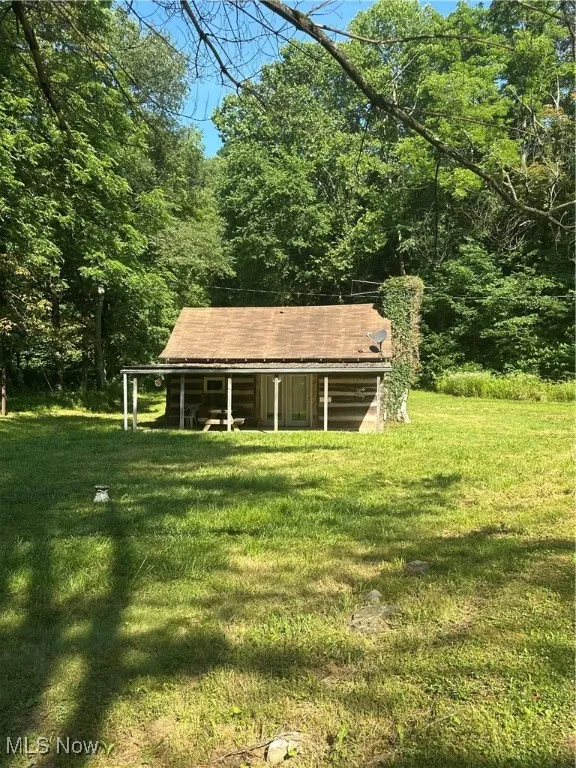 View of grassy yard featuring a forest view