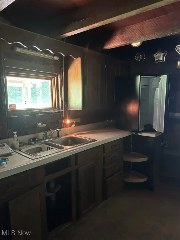 Kitchen featuring a sink and light countertops