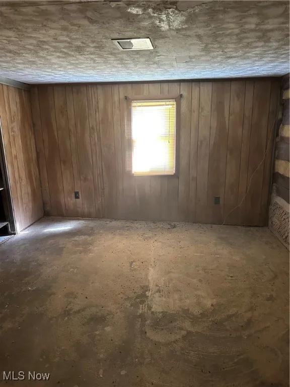 Bedroom on main floor with wood walls