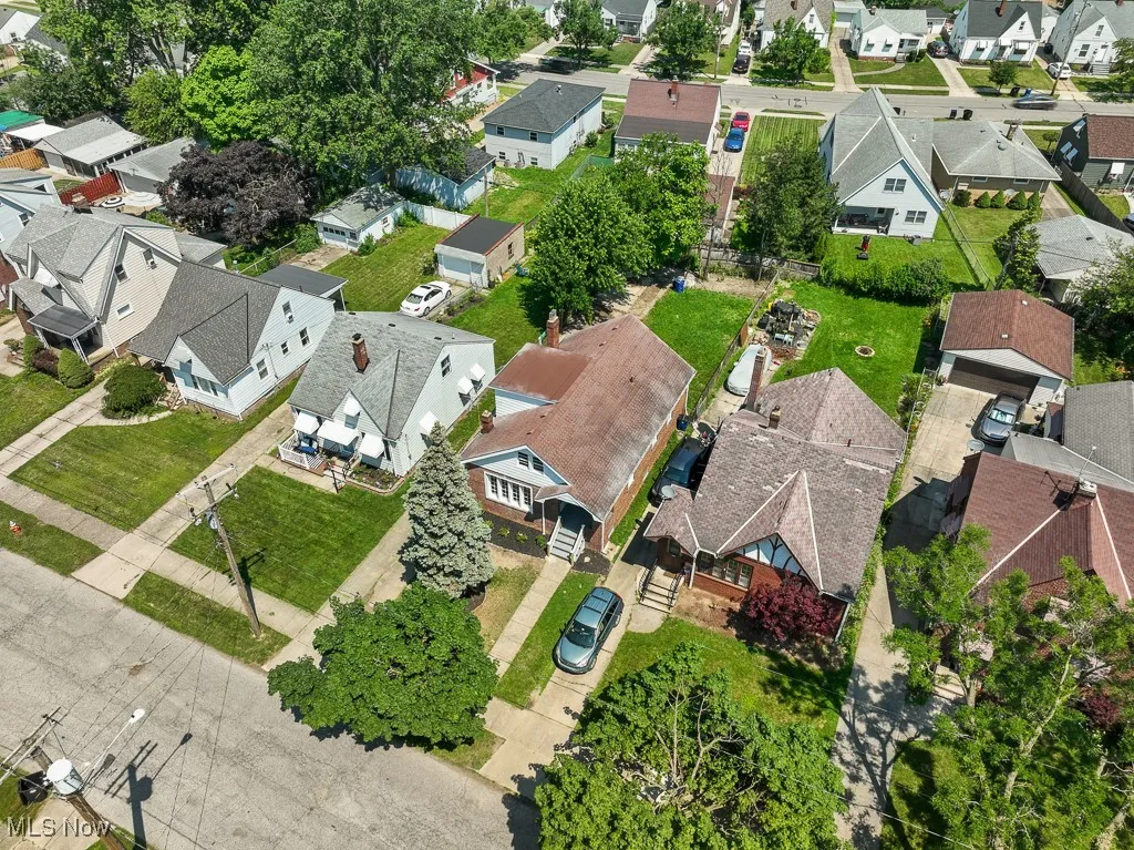 Aerial view of property's location with nearby suburban area