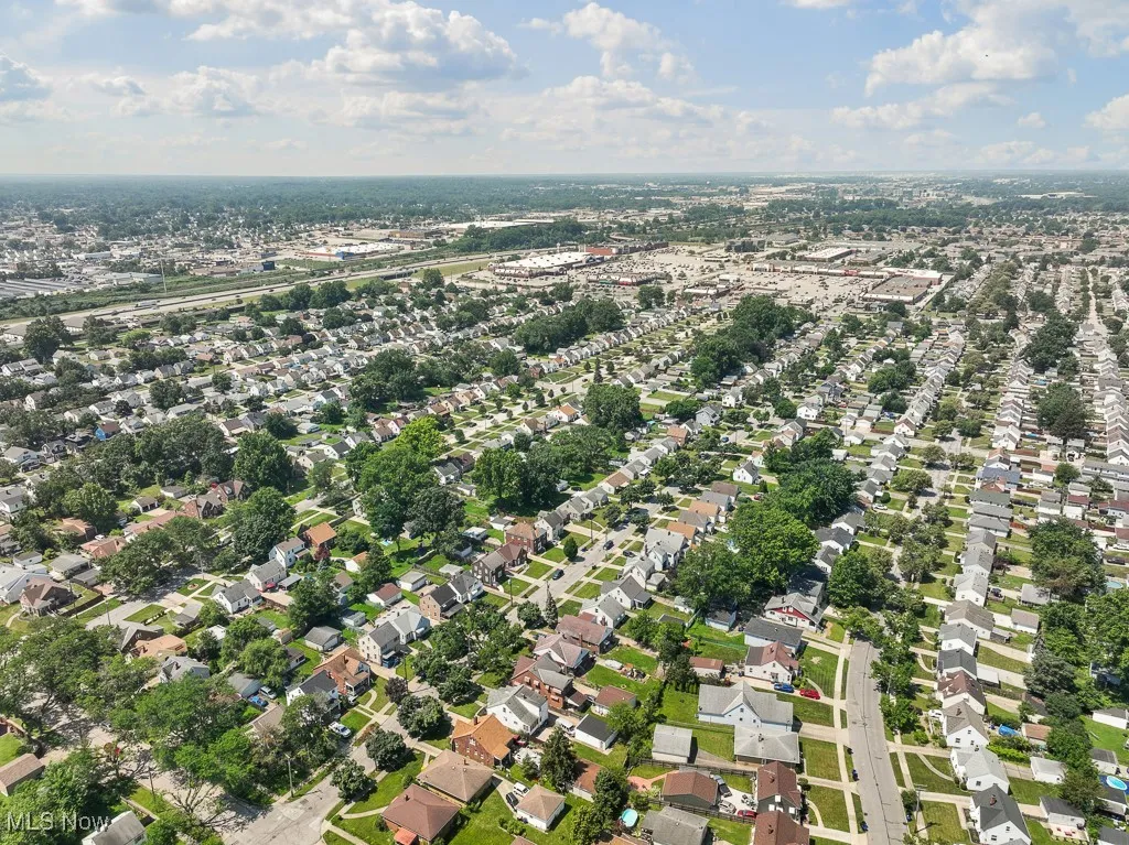 Aerial overview of property's location with nearby suburban area