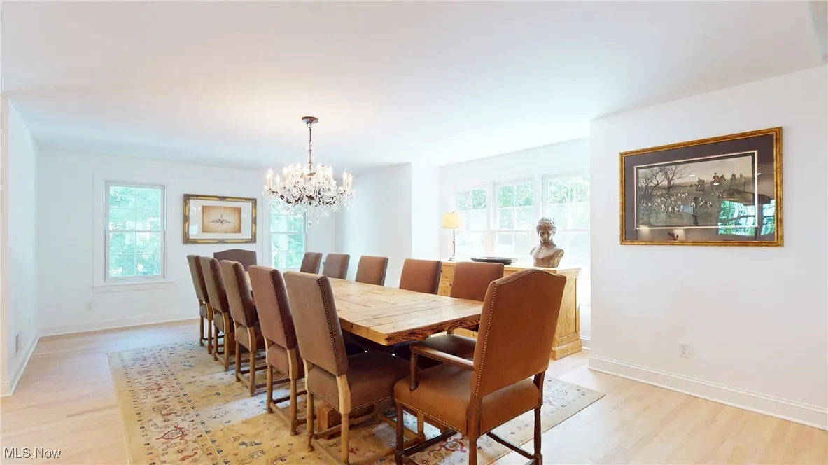 Full view of expanded Dining area with a Restoration Hardware cyrstal chandelier and new wood flooring
