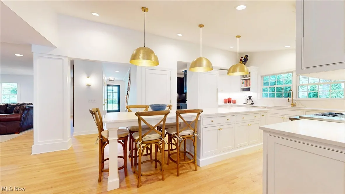 Rear Kitchen entrance featuring all new wood floors, recessed lighting, Brass dome pendants, all new custom cabinetry