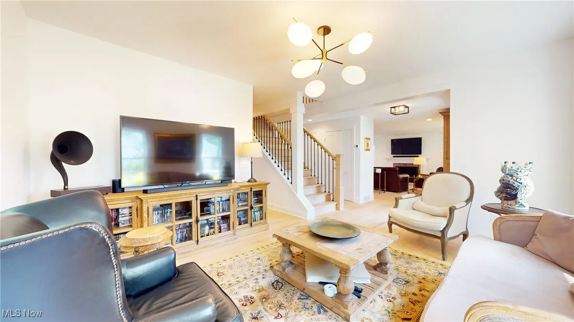 View of liivng room into family room and stairs to second floor