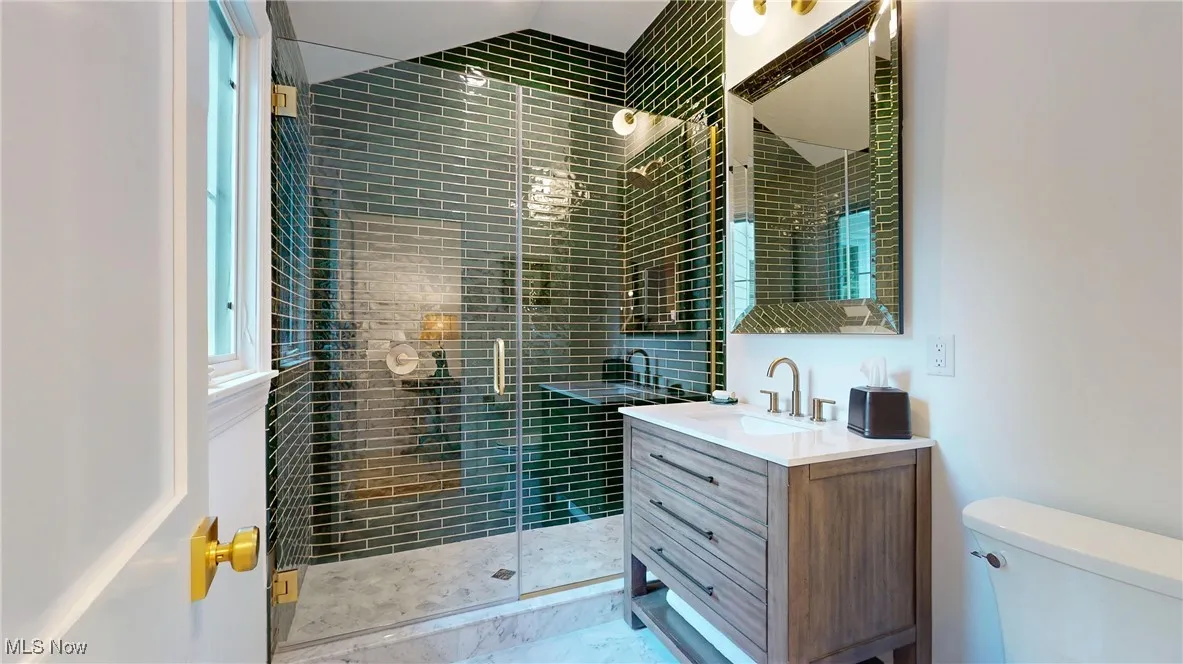 2nd Floor Hall Bathroom with vanity. shower features stunning hand painted emerald green subway tile imported from Malaga, Spain