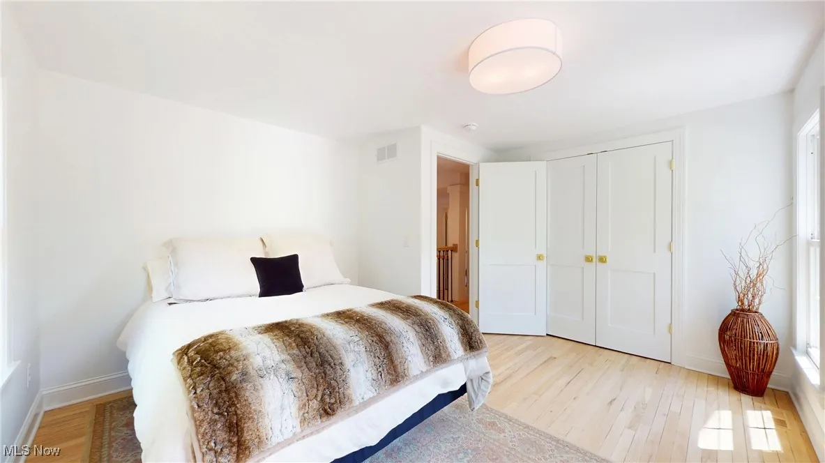 Guest Bedroom featuring will large closets and all new wood flooring