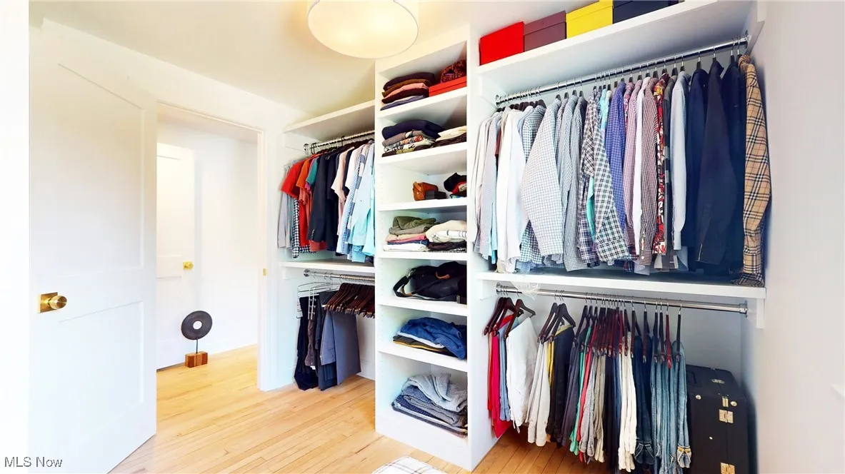 Spacious closet with new wood finished floors and all new custom closets