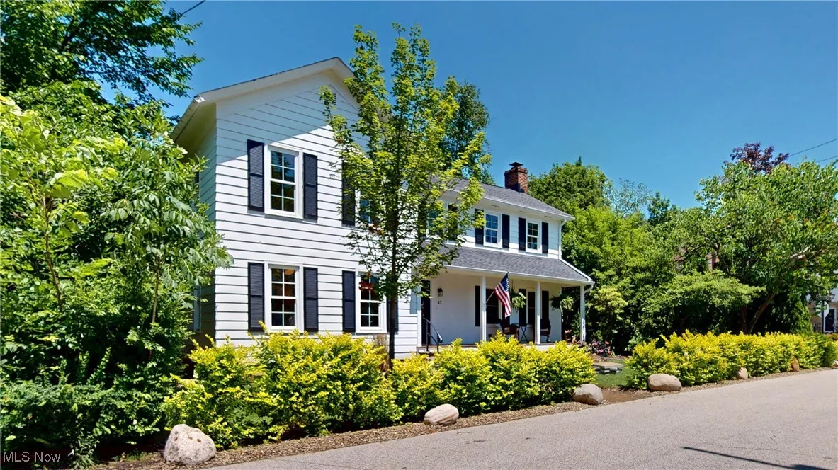 Colonial home with front porch and side yard