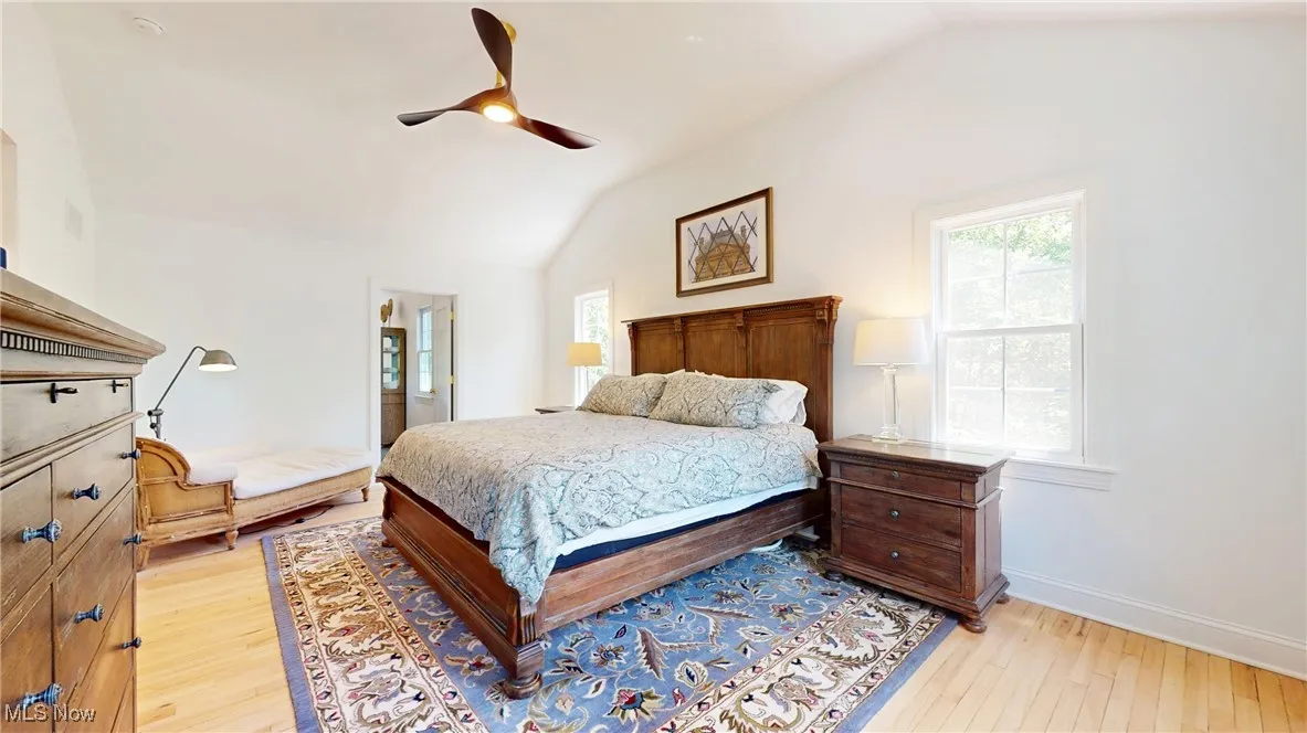 Primary Bedroom with vaulted ceiling, all new floors, and ceiling fan