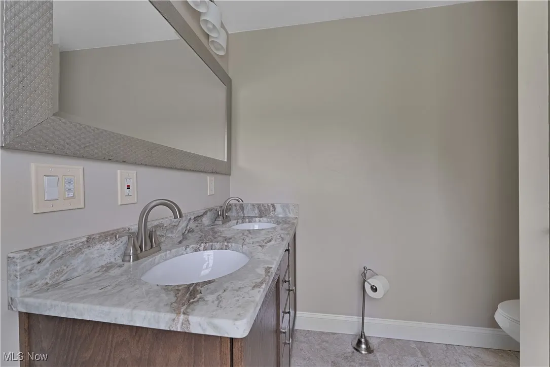 Bathroom with double vanity and toilet