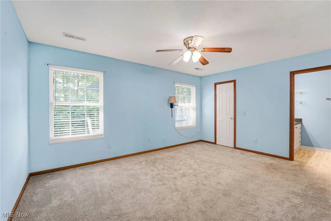 Spare room featuring carpet floors and ceiling fan