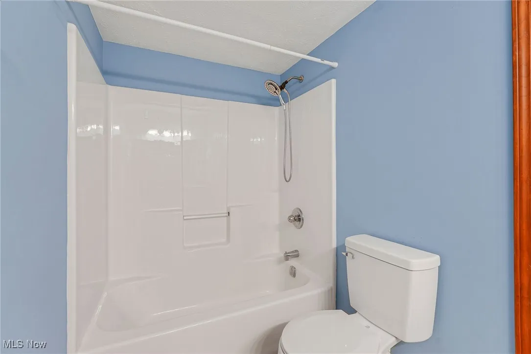Full bath with toilet and shower / tub combination