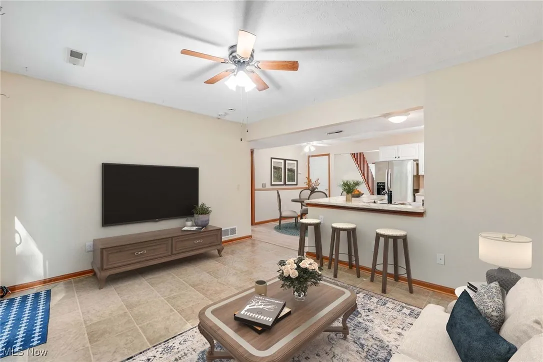 Virtually stage Living area featuring baseboards and ceiling fan