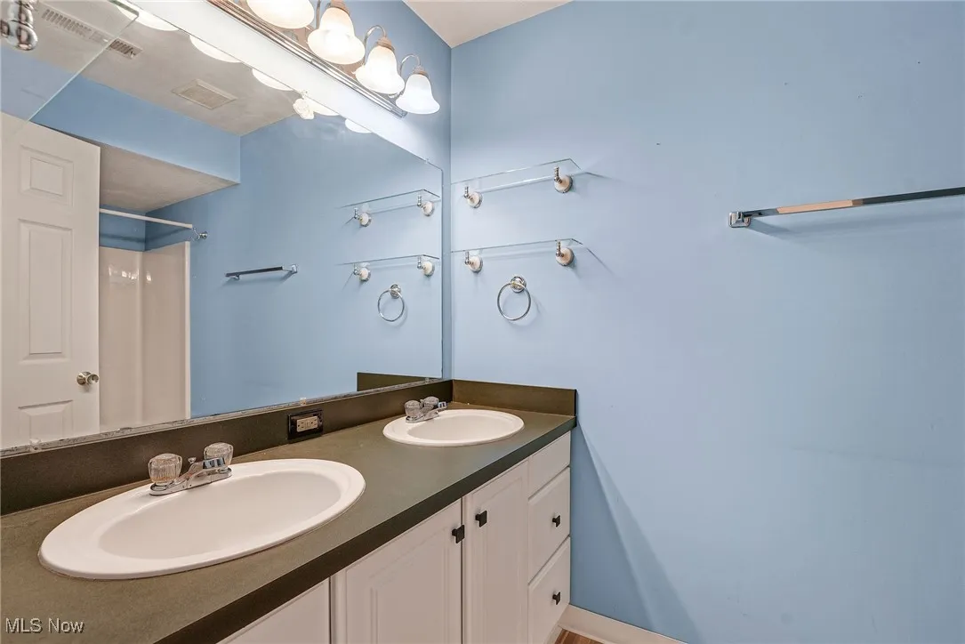 Bathroom with double vanity and a shower
