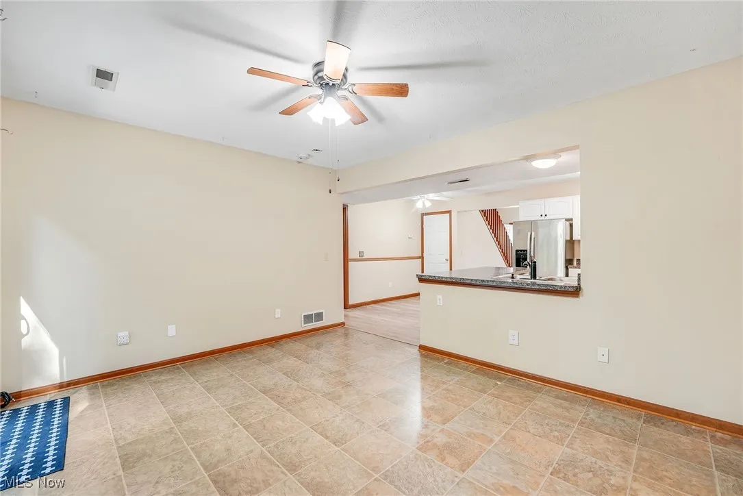 Spare room with ceiling fan and baseboards