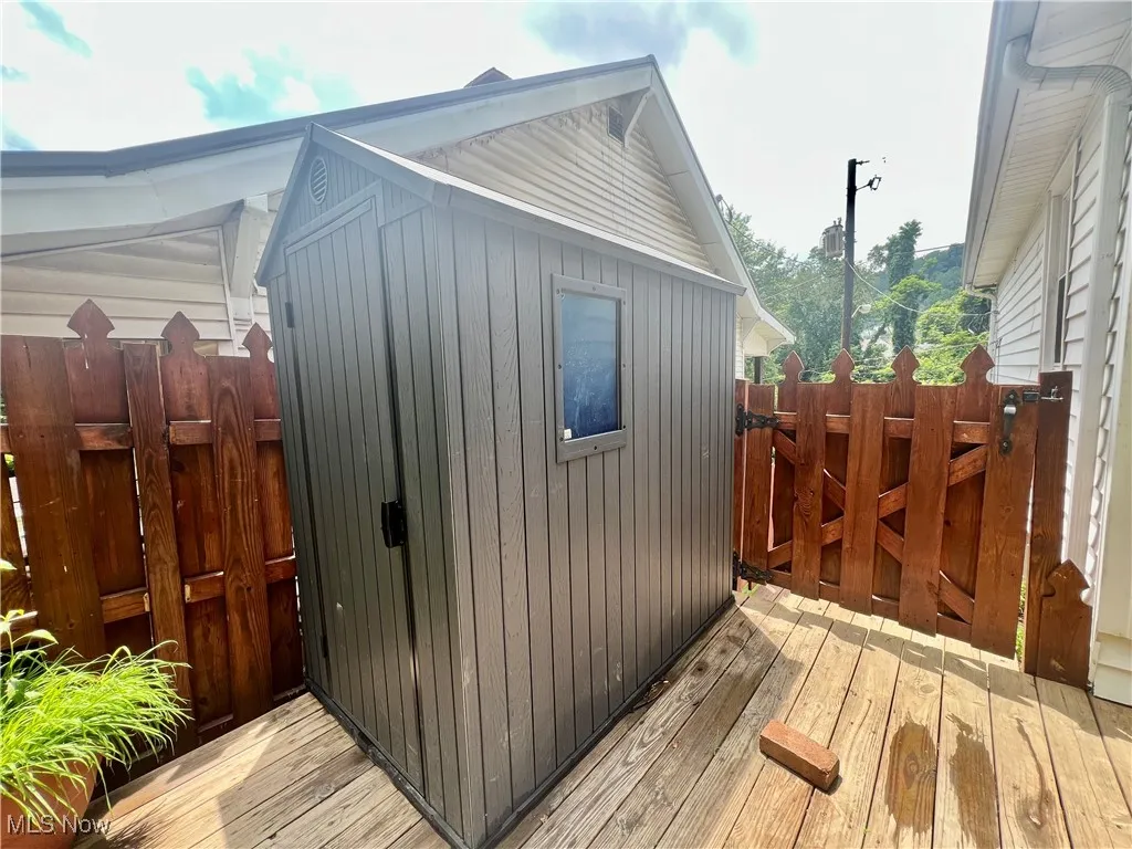 View of shed featuring a gate