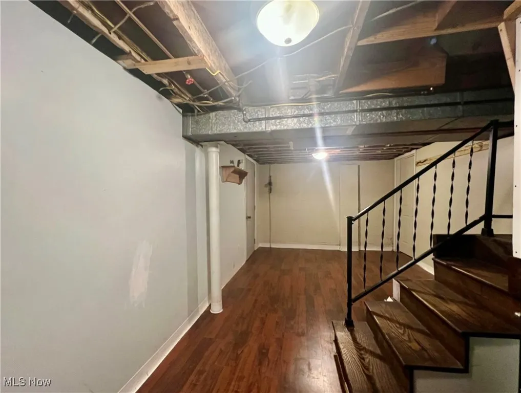 Basement with wood finished floors and stairs