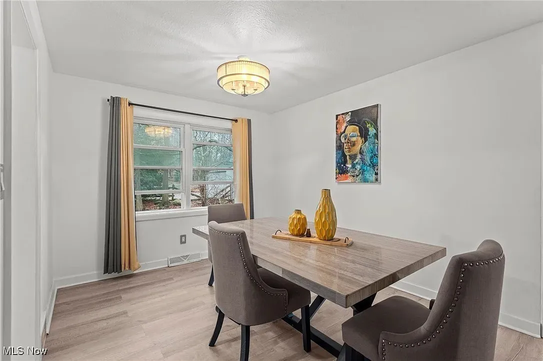 Dining room featuring light wood-style flooring and a chandelier