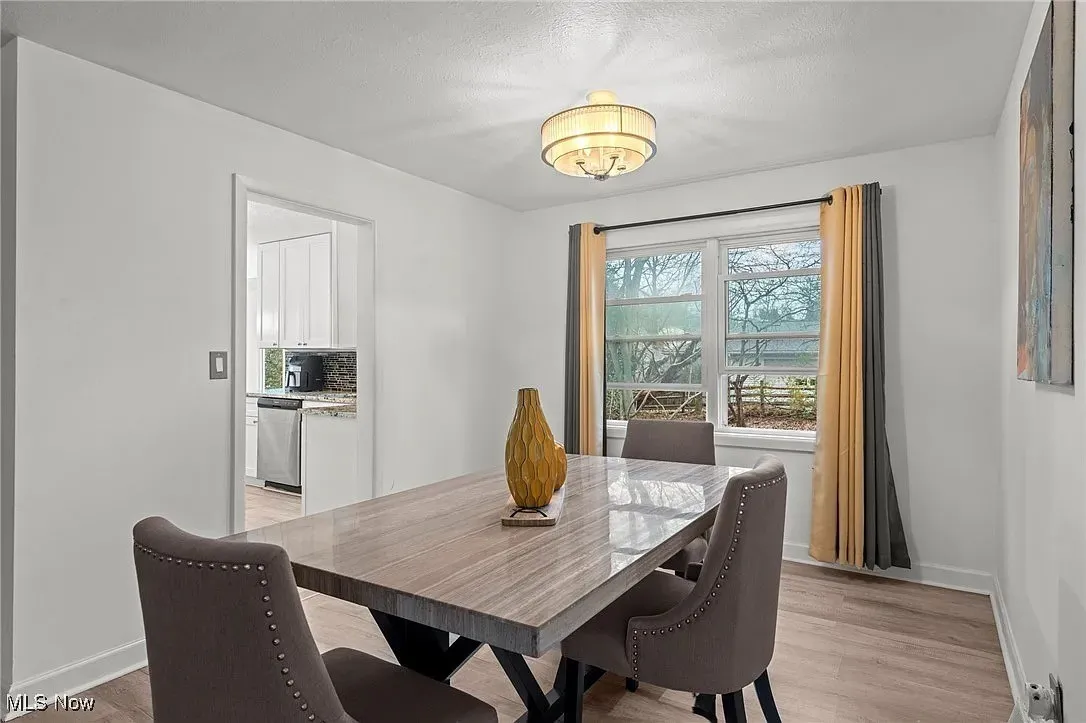Dining space featuring baseboards and light wood-style flooring