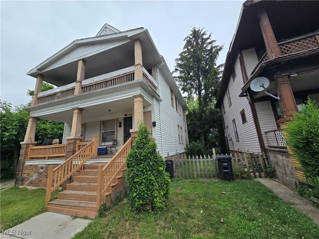 View of front of property with covered porch and a balcony