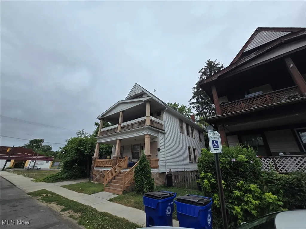 View of front of property featuring a balcony and a porch