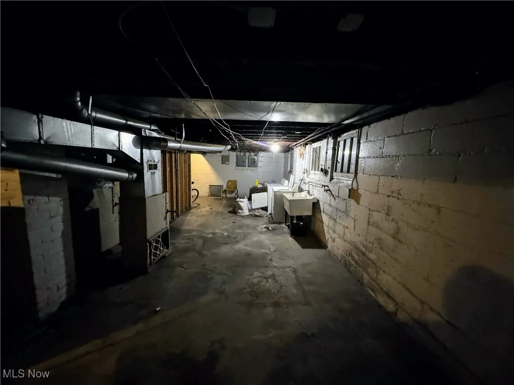 Unfinished basement featuring washing machine and dryer