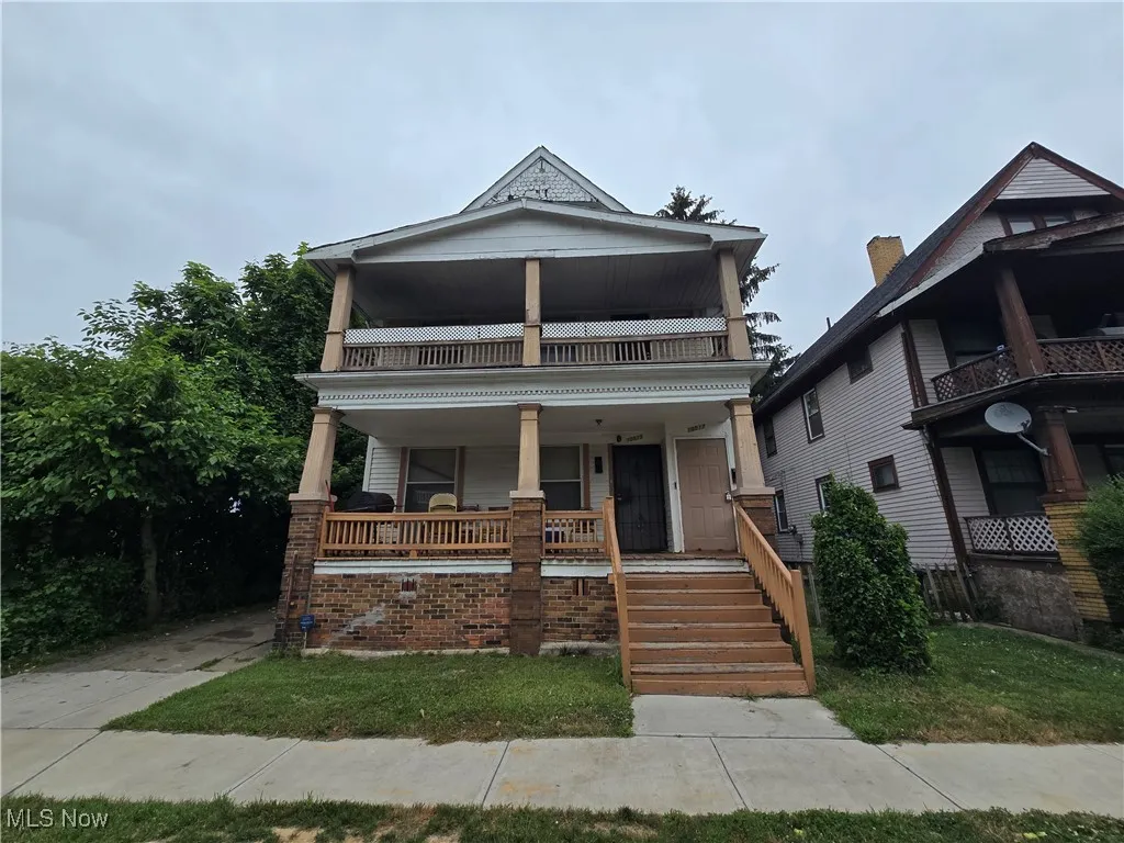 View of front of home with a balcony and a porch